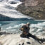 Researcher Emilio Mateo takes a rock sample in front of an iceberg-filled lake at the toe of Queshque Glacier, in the Cordillera Blanca, Peru. Credit: Evan Vega