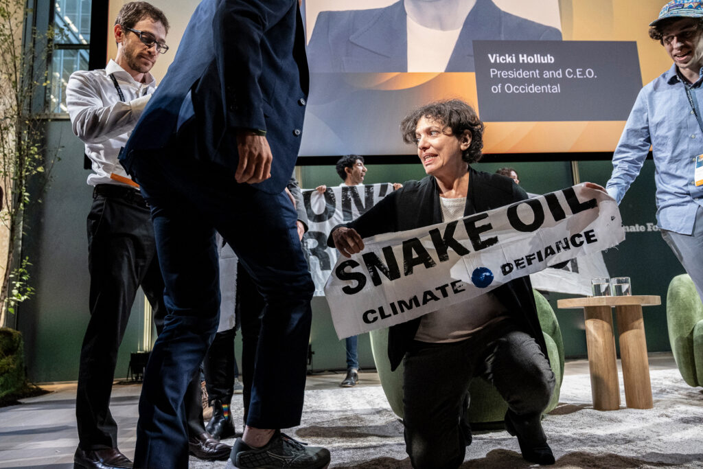 Climate Defiance members unfurled banners on stage and chanted "off fossil fuels, Times," and "Tricky Vicki, you can't hide, we charge you with ecocide." Credit: Ken Schles/Climate Defiance
