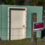 A newly constructed fence bearing a "no trespassing" sign stands in front of Sandy Pouncey's storm shelter. Credit: Lee Hedgepeth/Inside Climate News