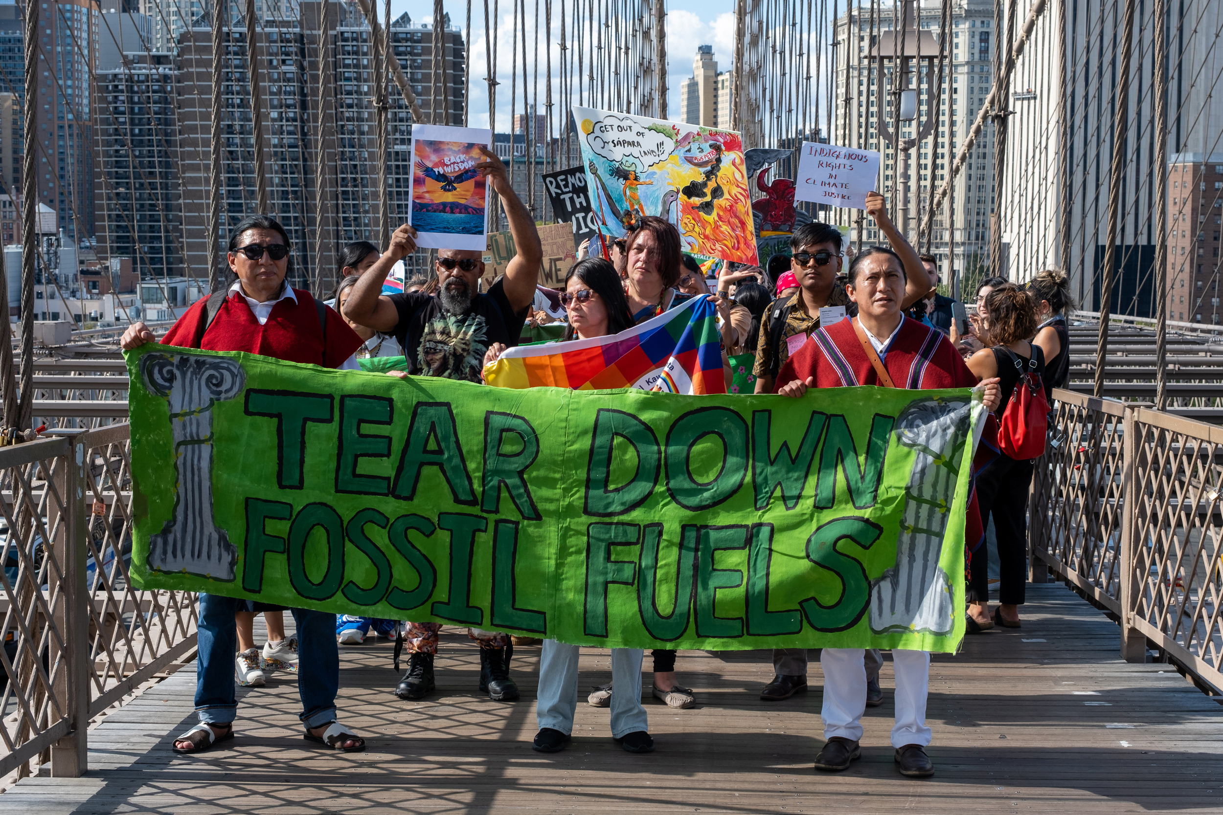 The activists marched across the Brooklyn bridge while a passersby stopped to film them and listen to their chants. Credit: Keerti Gopal/Inside Climate News