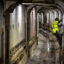 A worker climbs out of the walkway inside Hazel, the tunnel boring machine, on April 19, 2023 in Alexandria, Virginia. Credit: Bill O'Leary/The Washington Post via Getty Images