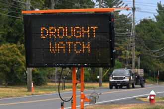 As drivers enter Purcellville, Virginia, they are reminded via road signs that farms in the area are under drought watch on Sept. 7, 2023. Credit: Michael S. Williamson/The Washington Post via Getty Images