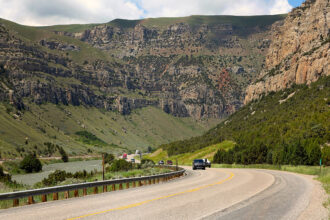Vehicles travel on U.S. Highway 20 along the Wind River through a canyon between the towns of Shoshoni and Thermopolis in central Wyoming. Credit: Don and Melinda Crawford/UCG/Universal Images Group via Getty Images