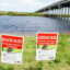 Health alert signs warn of a toxic blue-green algae bloom on Lake Jesup in Sanford, Florida. Credit: Jeffrey Greenberg/Universal Images Group via Getty Images