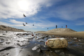 Plastic debris litters a drainage ditch to the sea at Junipero Beach in Long Beach, Calif. Credit: Luis Sinco/Los Angeles Times via Getty Images