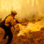 A firefighters extinguishes flames near State Road 172 as the Park Fire burns on Aug. 7 in Mill Creek, California. Credit: Ethan Swope/Getty Images