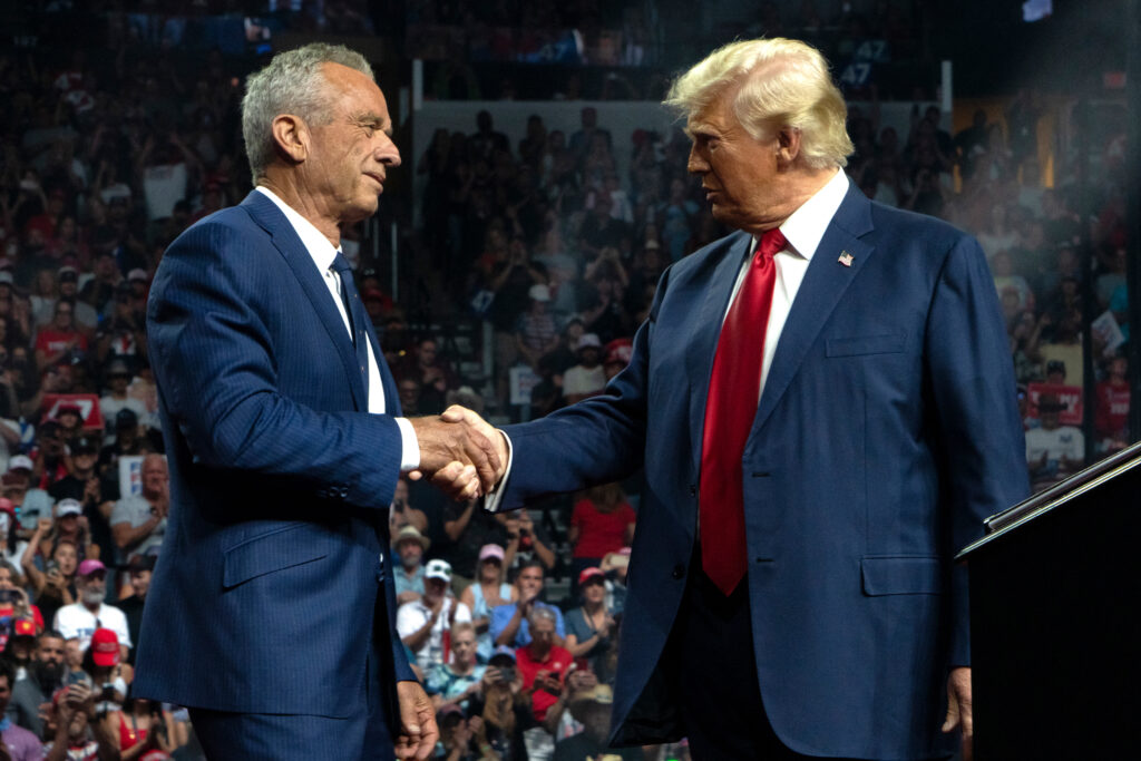 Robert F. Kennedy Jr. and former President Donald Trump shake hands during a campaign rally at Desert Diamond Arena on Aug. 23 in Glendale, Arizona. Credit: Rebecca Noble/Getty Images