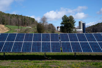 An array of solar panels is seen near a dairy farm in St George, Vermont. Credit: Robert Nickelsberg/Getty Images
