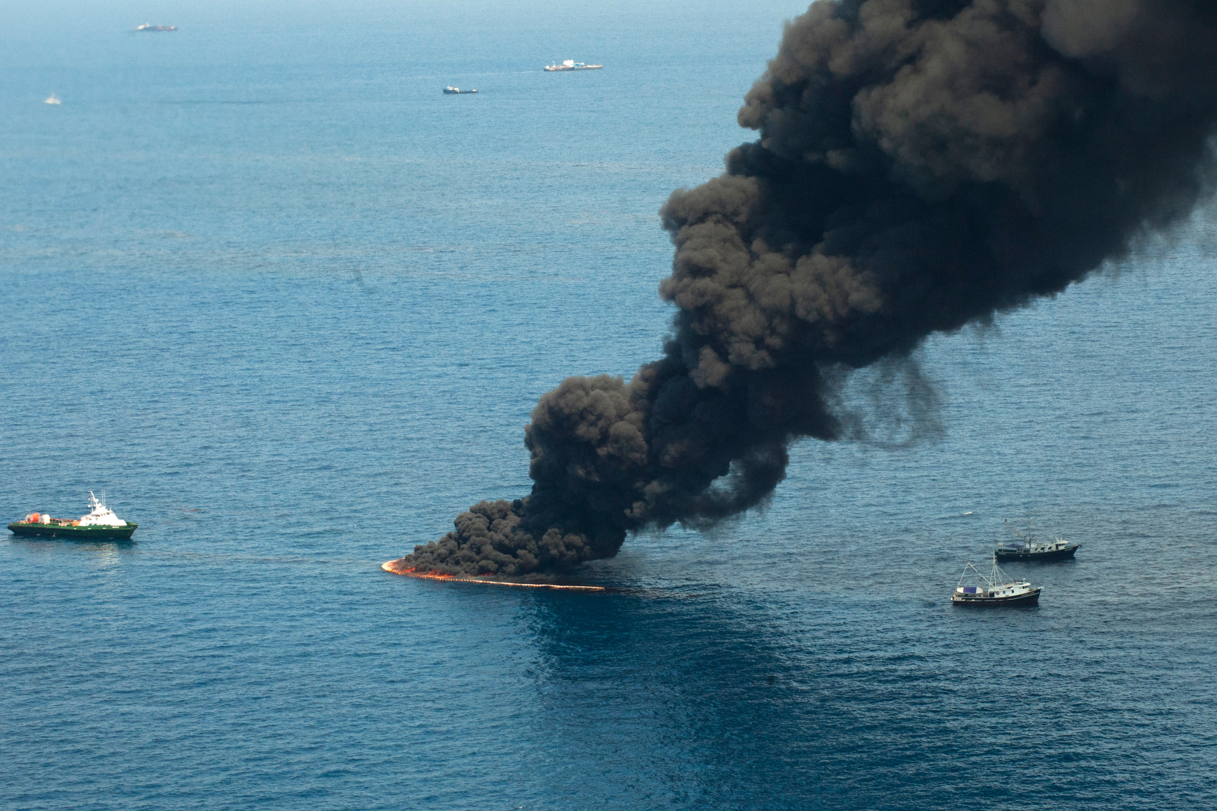 Smoke rises from a controlled burn of oil on the surface of the water near the site of the BP Deepwater Horizon oil spill in the Gulf of Mexico on July 11, 2010. Credit: Ken Cedeno/Corbis via Getty Images