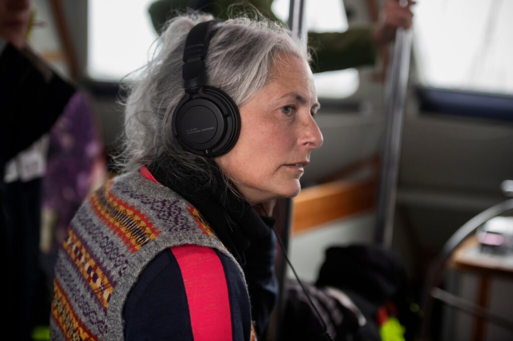 Dr. Kirsten Young, a molecular ecologist and conservation biologist, conducts an acoustic survey for whales onboard the Witness. Credit: Christian Åslund/Greenpeace