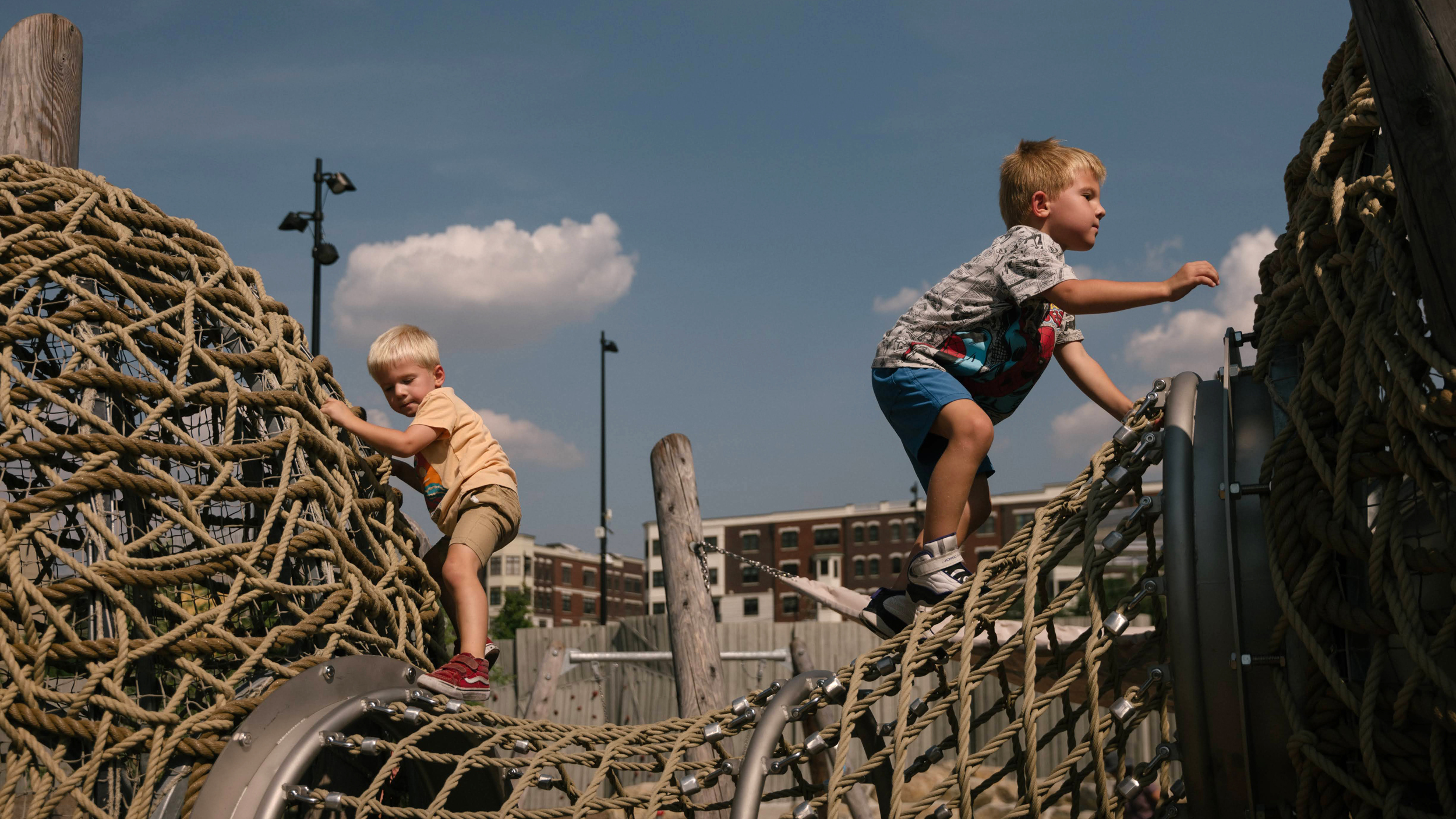 Benno, 3, and Theo Schmitt, 5, climb on ropes in the Play Valley at ResilienCity Park on Aug. 27 in Hoboken, New Jersey. Credit: Caroline Gutman/Inside Climate News