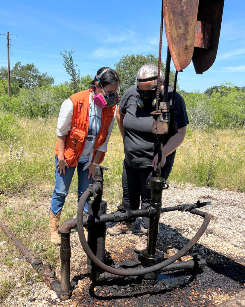 Abigail Edgar (left) and Amy Townsend-Small observe a bubbling gas leak in May 2023 at a well that state records list as inactive. Credit: Courtesy of Abigail Edgar