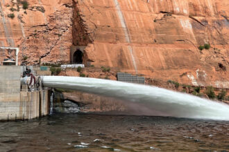 Water flows through Glen Canyon Dam's river outlet works. The pipes will undergo $9 million in repairs, but conservation groups want to see more permanent renovations at the dam, which holds back Lake Powell as Colorado River supplies shrink. Credit: Bureau of Reclamation